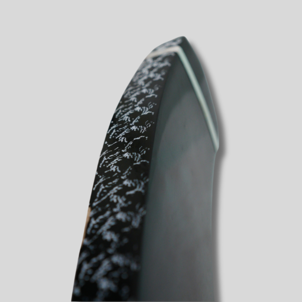 Black and gray textured object on a light gray background