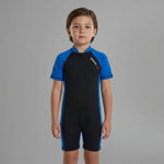 Child wearing a black and blue Speedo swimsuit on a gray background